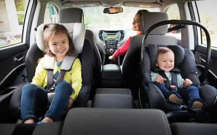 Children secured in car seats during a private family taxi transfer in Melbourne